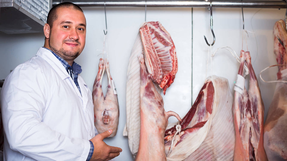 Butcher in meat store